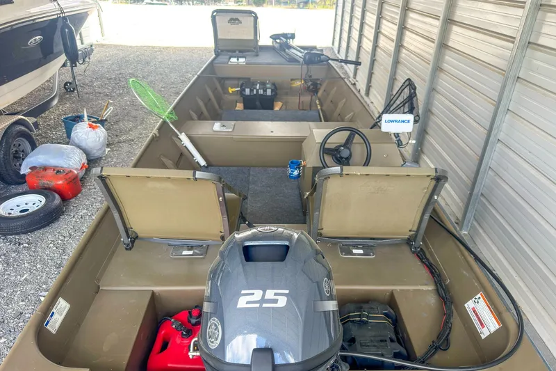 Slide: The Image of 2022 G3 1648 LW boat with 25 HP motor, stored in a covered area. - 13