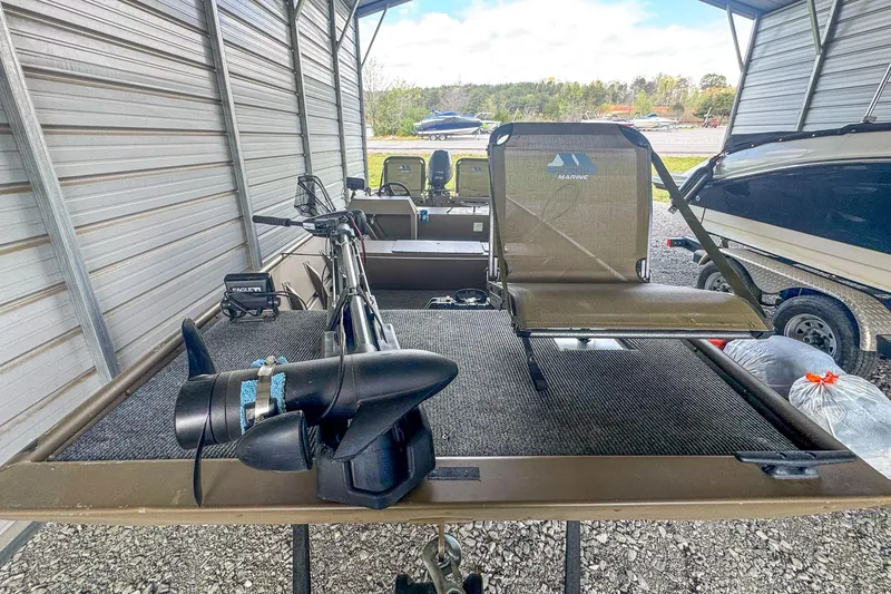 Slide: The Image of 2022 G3 1648 LW boat with motor and seating in a covered storage area. - 17