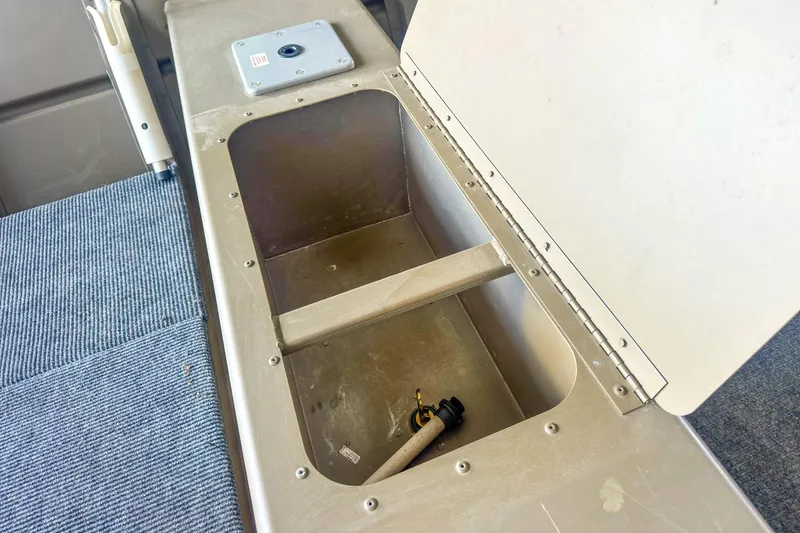 Slide: The Image of Open storage compartment in a 2022 G3 1648 LW boat, featuring a carpeted floor. - 21