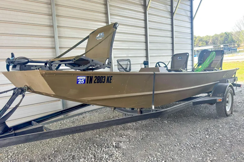 Slide: The Image of 2022 G3 1648 LW boat on trailer, parked in a covered area. - 3