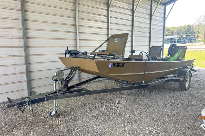 Slide: The Image of 2022 G3 1648 LW boat on trailer, parked in a covered area. - 4