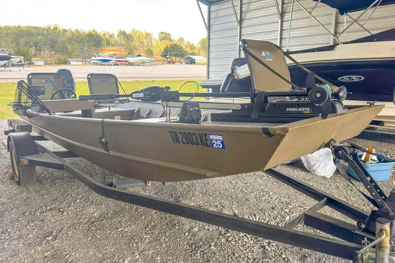 Slide: The Image of 2022 G3 1648 LW boat on trailer with Minn Kota motor, parked outdoors. - 5