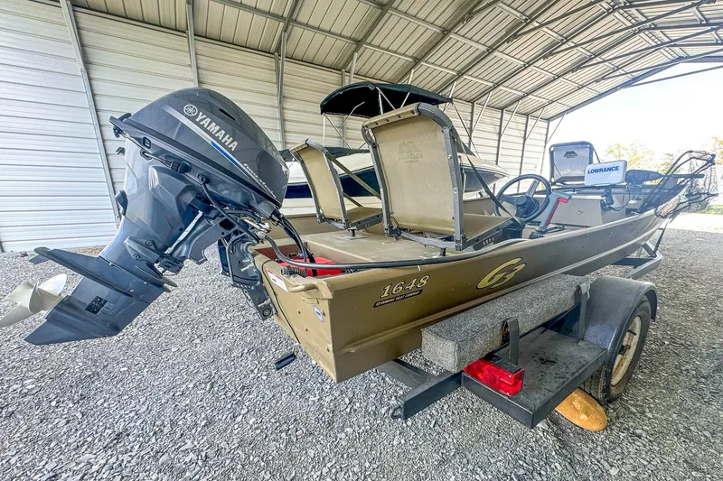 Slide: The Image of 2022 G3 1648 LW boat with Yamaha motor on trailer in covered storage. - 8