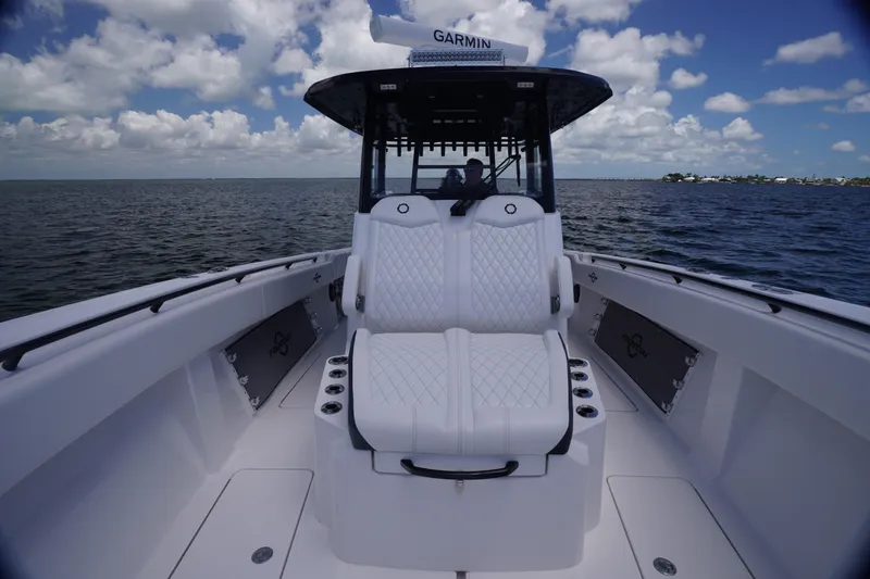 Slide: The Image of 2023 Fountain 38 Tournament Edition boat interior with white seating on open water. - 12