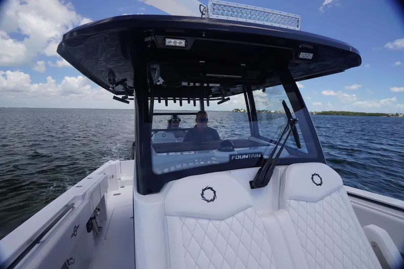 Slide: The Image of 2023 Fountain 38 Tournament Edition boat cruising on open water under a clear sky. - 14