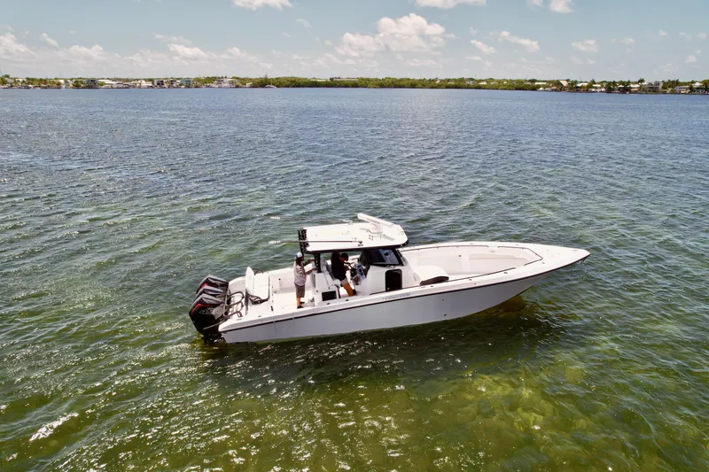 Slide: The Image of 2023 Fountain 38 Tournament Edition boat on calm water under a clear sky. - 2