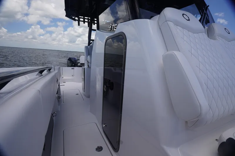 Slide: The Image of 2023 Fountain 38 Tournament Edition boat interior with white seating and ocean view. - 21