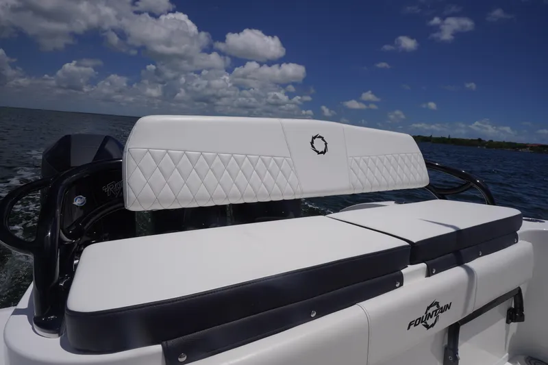 Slide: The Image of 2023 Fountain 38 Tournament Edition boat with white cushioned seating on open water. - 35