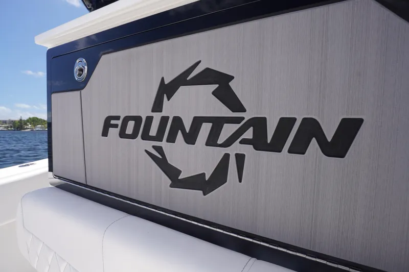 Slide: The Image of 2023 Fountain 38 Tournament Edition boat logo on sleek panel by water. - 38