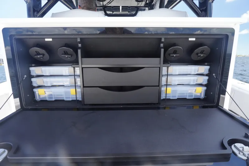 Slide: The Image of Storage compartment on a 2023 Fountain 38 Tournament Edition boat, featuring organized tackle boxes. - 40