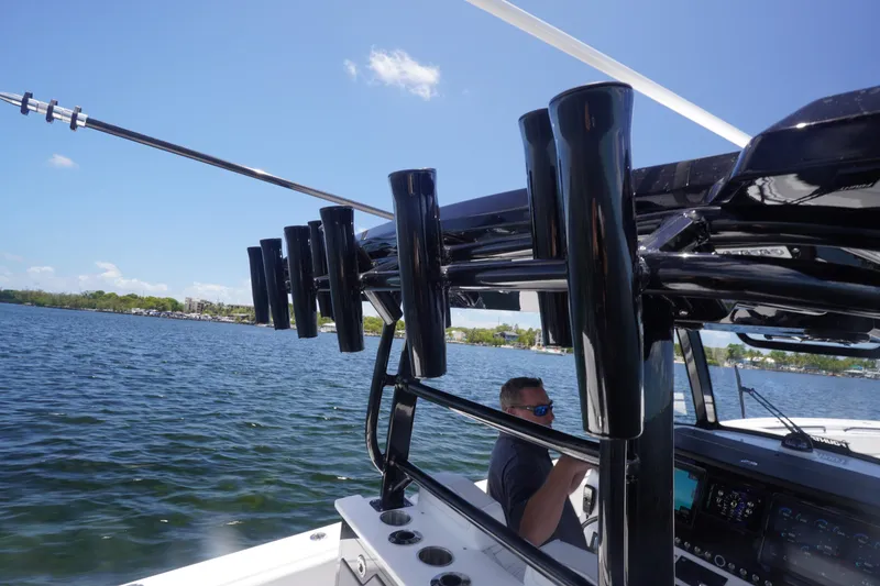 Slide: The Image of 2023 Fountain 38 Tournament Edition boat on water, featuring rod holders and console. - 42