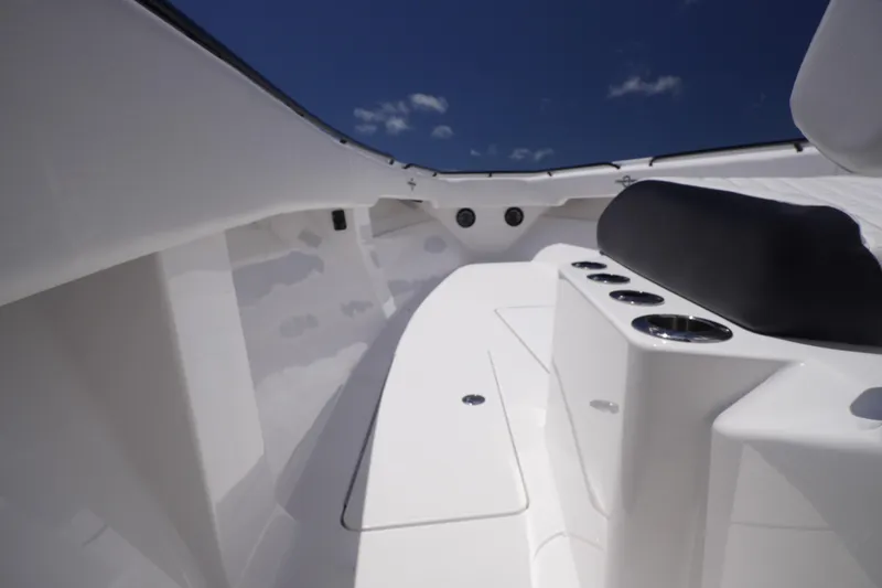 Slide: The Image of 2023 Fountain 38 Tournament Edition boat interior with sleek white design and cup holders. - 46