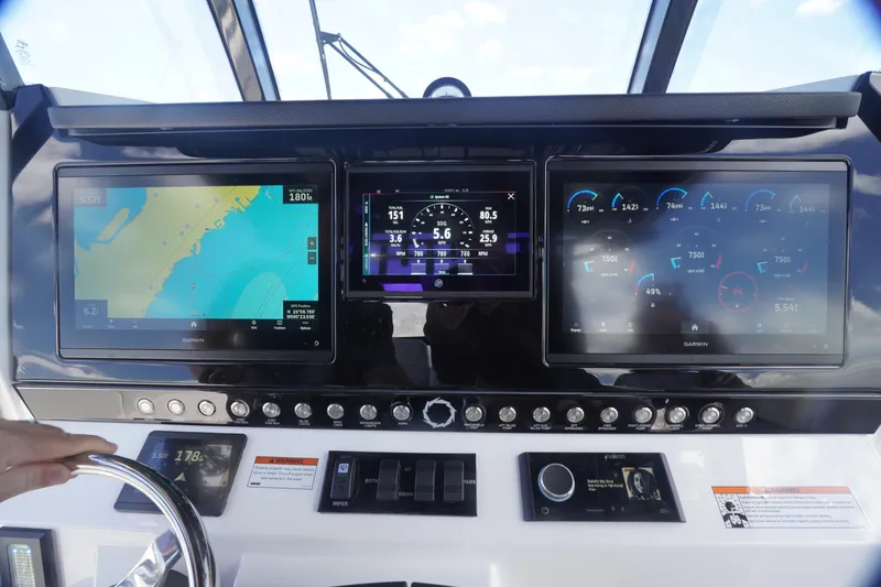 Slide: The Image of Dashboard of 2023 Fountain 38 Tournament Edition boat with navigation and control screens. - 49