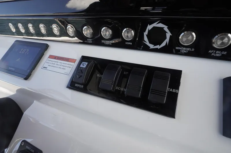 Slide: The Image of Control panel of 2023 Fountain 38 Tournament Edition boat with switches and display. - 55