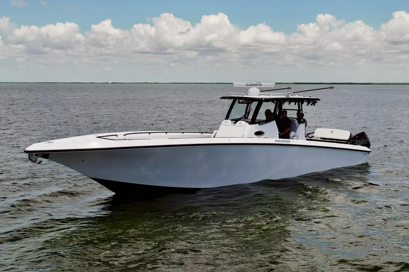 Slide: The Image of 2023 Fountain 38 Tournament Edition boat cruising on open water under a cloudy sky. - 56