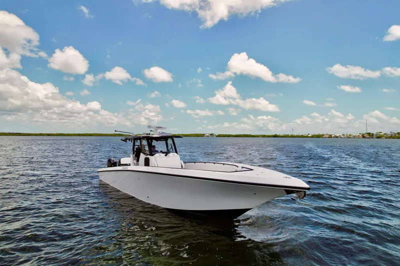 Slide: The Image of 2023 Fountain 38 Tournament Edition boat on open water under a clear blue sky. - 59