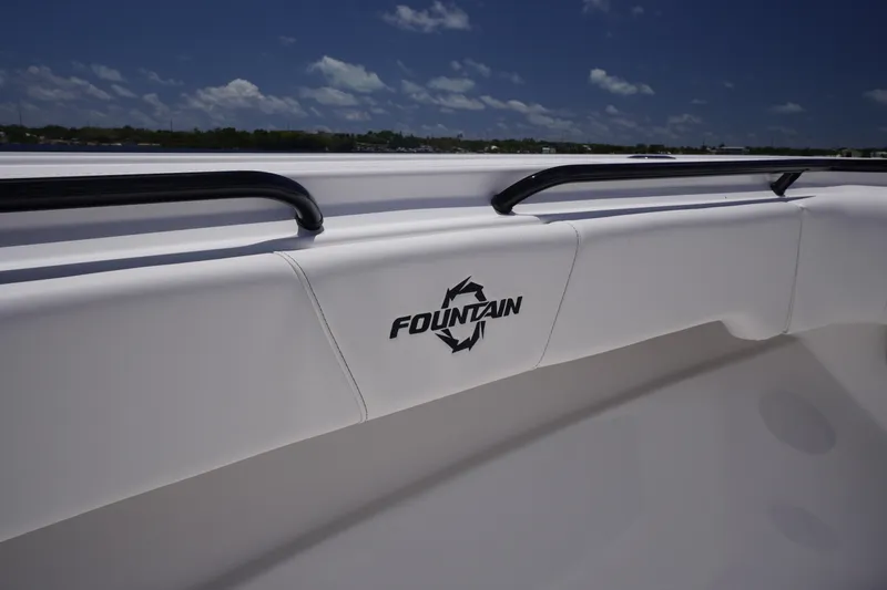Slide: The Image of 2023 Fountain 38 Tournament Edition boat interior with logo and railing under blue sky. - 6