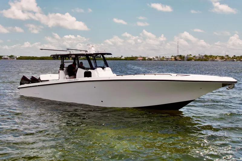 Slide: The Image of 2023 Fountain 38 Tournament Edition boat on calm water under a clear sky. - 60