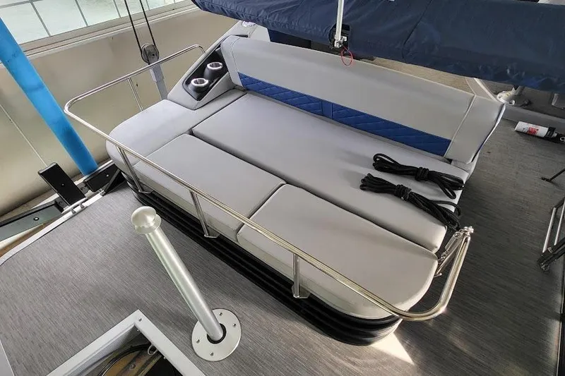 Slide: The Image of 2023 Bennington L 25 Swingback boat interior with cushioned seating and cup holders. - 10