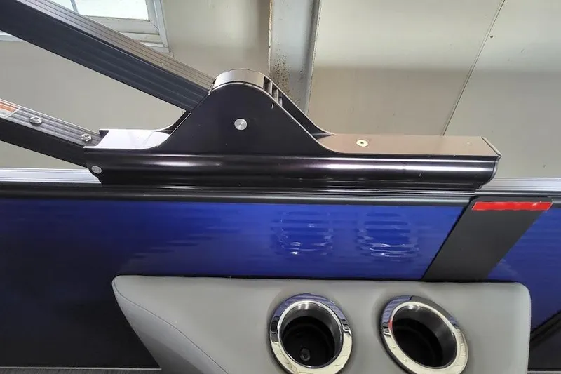Slide: The Image of 2023 Bennington L 25 Swingback boat detail with blue panel and cup holders. - 14
