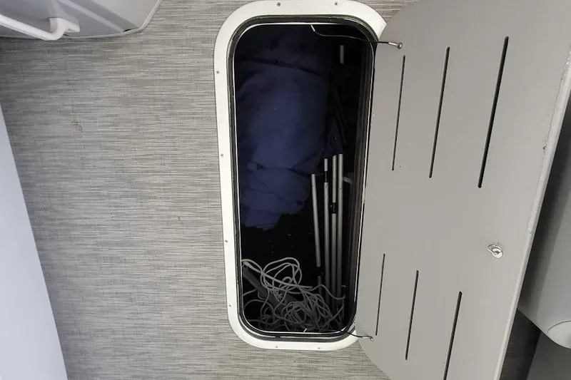 Slide: The Image of Storage compartment on 2023 Bennington L 25 Swingback boat with ropes and equipment. - 17