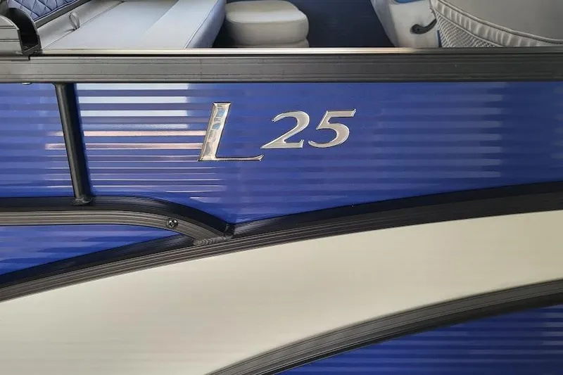 Slide: The Image of 2023 Bennington L 25 Swingback boat, blue exterior with model name displayed. - 18