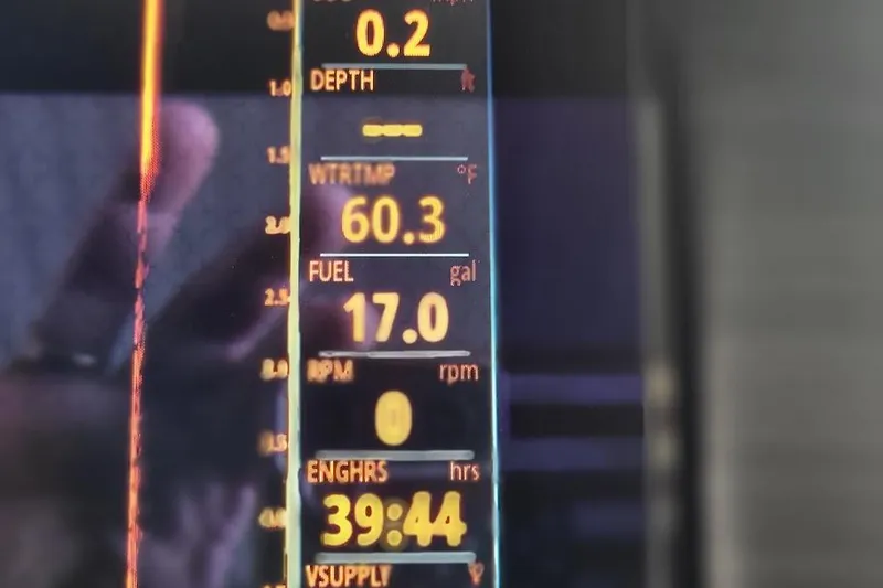 Slide: The Image of Display panel of 2023 Bennington L 25 Swingback showing depth, water temperature, and fuel levels. - 5