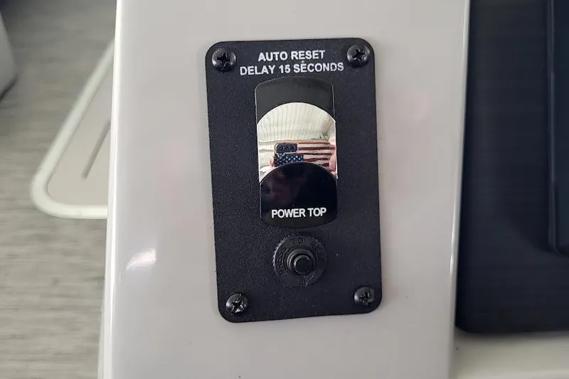 Slide: The Image of Control panel of 2023 Bennington L 25 Swingback with auto reset and power top switch. - 6