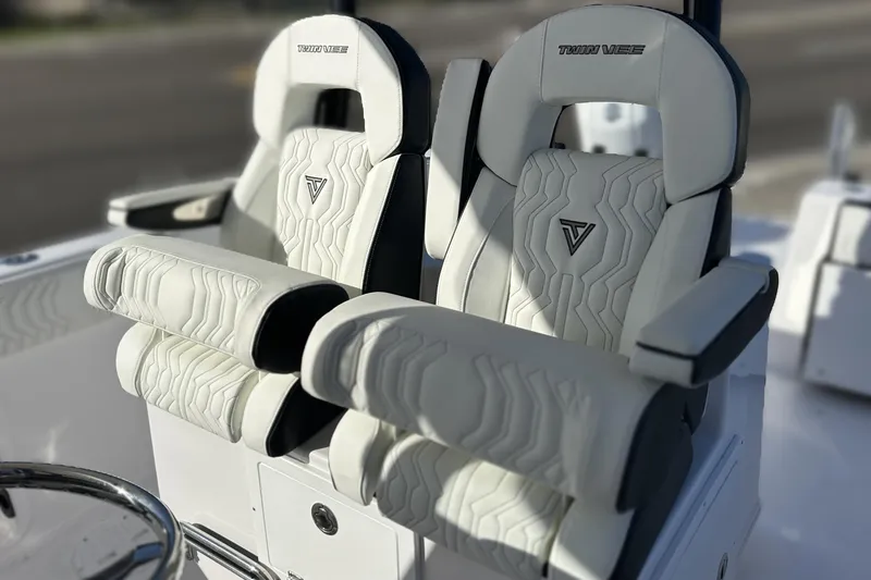 Slide: The Image of 2026 Twin Vee 260 GFX2 CC boat seats with elegant white upholstery and armrests. - 10