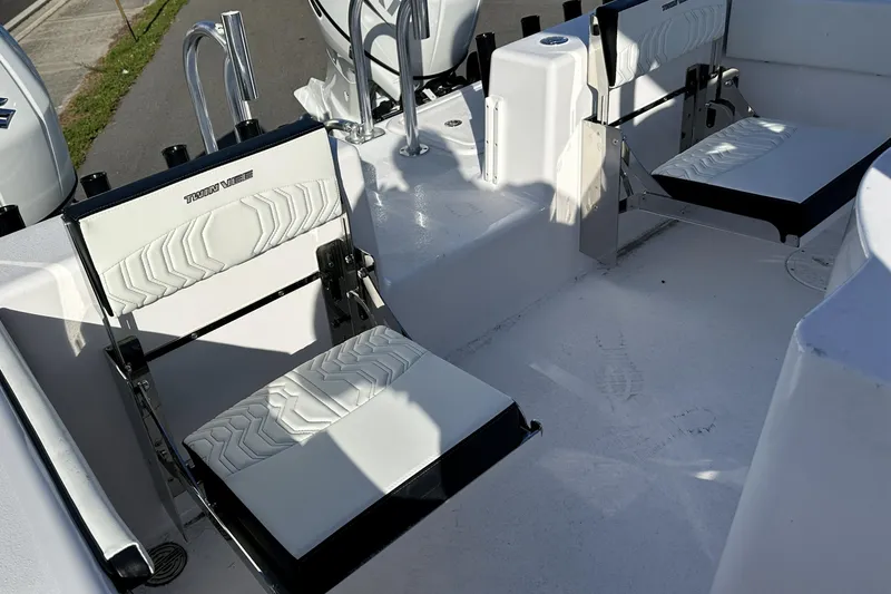 Slide: The Image of 2026 Twin Vee 260 GFX2 CC boat interior with white cushioned seats. - 11