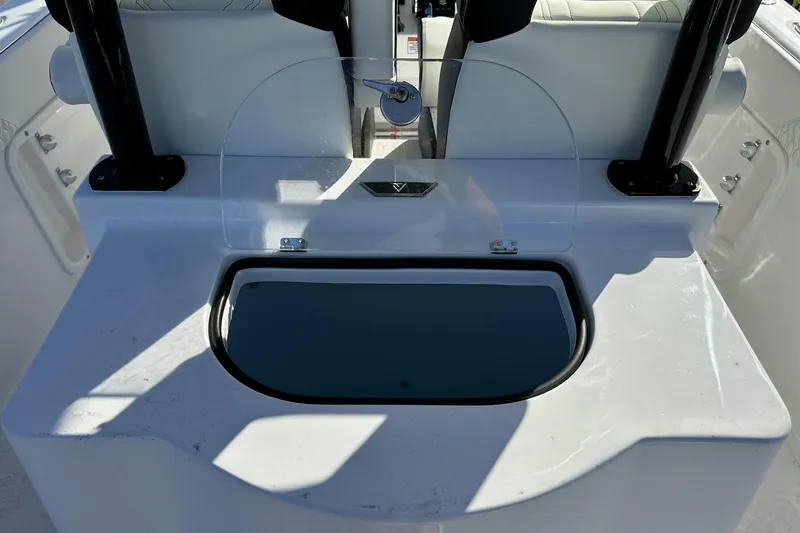 Slide: The Image of 2026 Twin Vee 260 GFX2 CC boat interior with seating and storage compartment. - 13