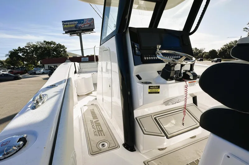 Slide: The Image of 2026 Twin Vee 260 GFX2 CC boat interior with steering console and seating. - 14