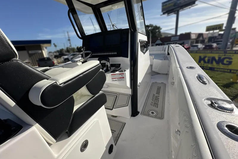Slide: The Image of 2026 Twin Vee 260 GFX2 CC boat interior with modern seating and control panel. - 15