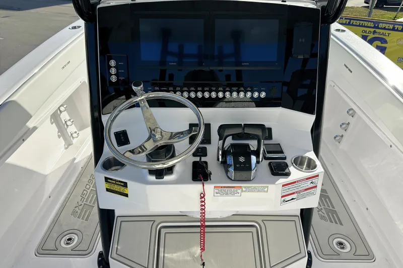 Slide: The Image of 2026 Twin Vee 260 GFX2 CC boat console with steering wheel and modern controls. - 16