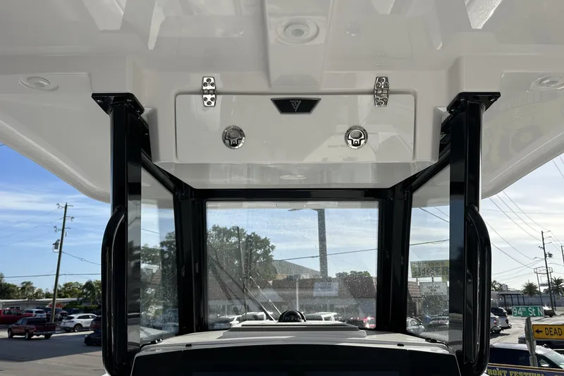Slide: The Image of 2026 Twin Vee 260 GFX2 CC boat interior with sturdy black frame and clear windows. - 17