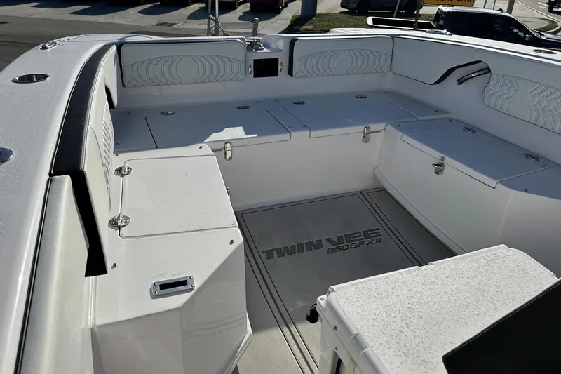 Slide: The Image of Interior view of 2026 Twin Vee 260 GFX2 CC boat, featuring spacious seating and storage. - 18