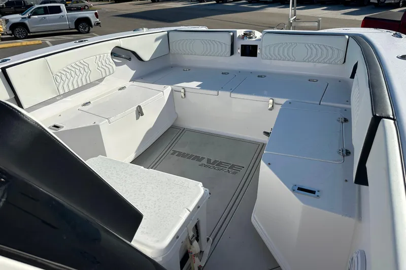 Slide: The Image of 2026 Twin Vee 260 GFX2 CC boat interior with spacious seating and storage compartments. - 19