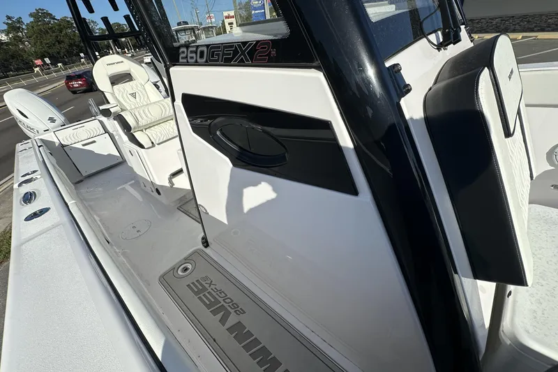 Slide: The Image of 2026 Twin Vee 260 GFX2 CC boat interior with white seating and sleek design. - 20