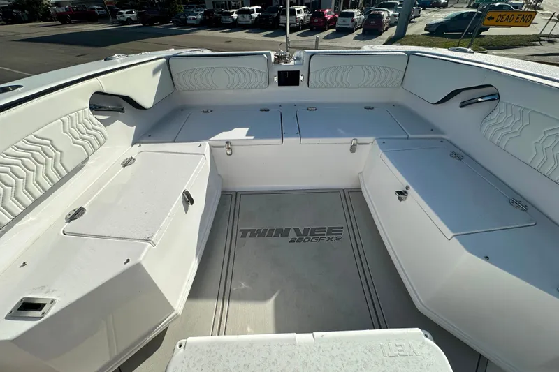 Slide: The Image of 2026 Twin Vee 260 GFX2 CC boat interior with seating and storage compartments. - 22