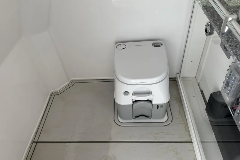 Slide: The Image of Portable toilet in 2026 Twin Vee 260 GFX2 CC boat cabin interior. - 24
