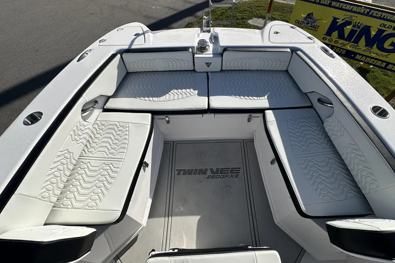 Slide: The Image of 2026 Twin Vee 260 GFX2 CC boat interior with white cushioned seating and sleek design. - 30