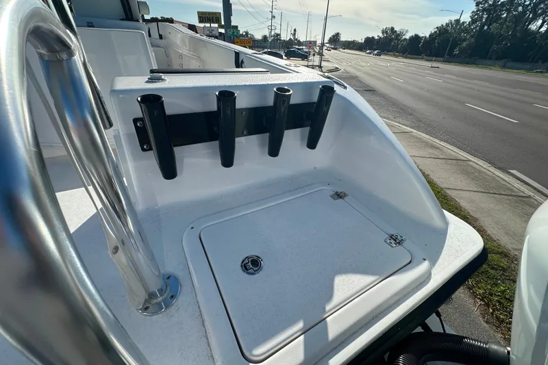 Slide: The Image of 2026 Twin Vee 260 GFX2 CC boat deck with rod holders and storage compartment. - 6