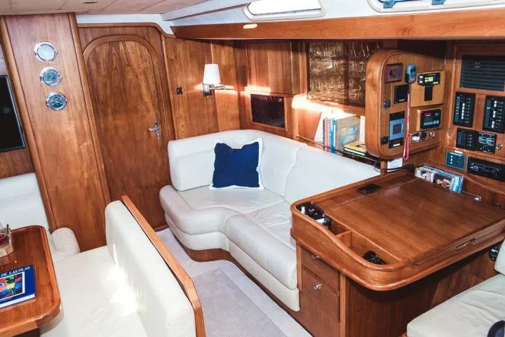 Slide: The Image of Luxurious 1997 Gorbon Custom 66 yacht interior with elegant wood paneling and plush seating. - 125