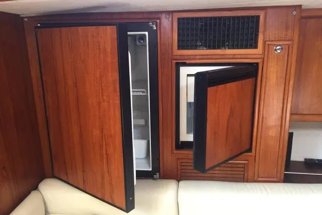 Slide: The Image of Built-in wooden cabinets with open fridge and freezer on Gorbon Custom 66 yacht, 1997 model. - 128