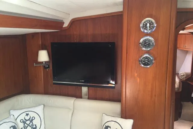 Slide: The Image of Interior of 1997 Gorbon Custom 66 yacht with TV, wooden paneling, and nautical decor. - 129