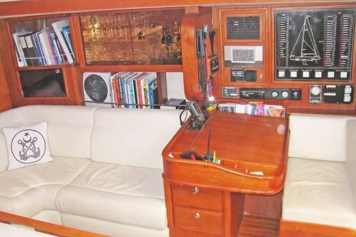 Slide: The Image of Luxurious Gorbon Custom 66 yacht interior with navigation station, bookshelves, and plush seating, 1997 model. - 133