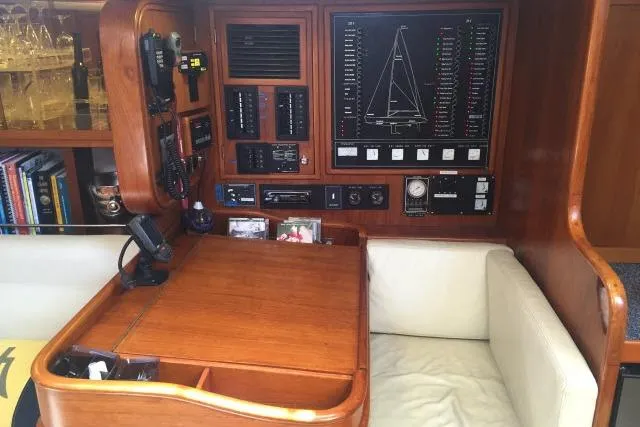 Slide: The Image of Navigation station of 1997 Gorbon Custom 66 yacht with control panels and seating. - 134