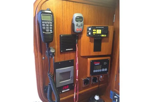Slide: The Image of Control panel of a 1997 Gorbon Custom 66 yacht with communication devices. - 136