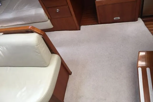 Slide: The Image of Interior of a 1997 Gorbon Custom 66 yacht with wooden cabinetry and beige seating. - 138