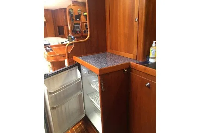 Slide: The Image of Wooden yacht interior with open fridge, Gorbon Custom 66, 1997 model. - 141
